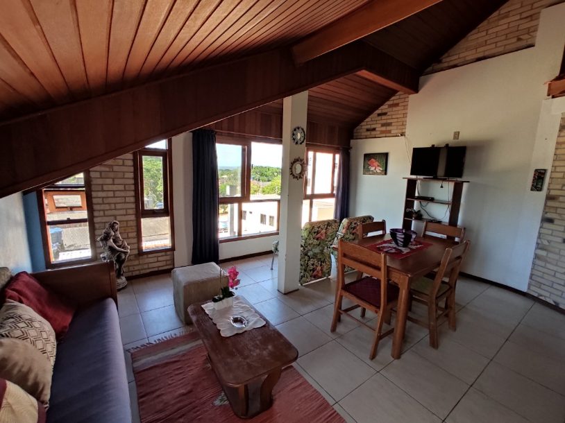 Sala de estar e jantar de uma das acomodações da Pousada Capricórnio, com vista para o mar